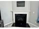 Modern fireplace with black marble surround at 1380 Delacorte Cir, Shelbyville, IN 46176