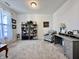 Bright home office with modern desk, bookshelves, comfortable chair, and large window at 1380 Delacorte Cir, Shelbyville, IN 46176