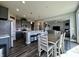 Open kitchen and dining area features stainless steel appliances, gray cabinetry, and a view into the living room at 1380 Delacorte Cir, Shelbyville, IN 46176
