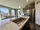 A kitchen showcasing stainless steel appliances, gray cabinetry, and a bright, stylish design at 1380 Delacorte Cir, Shelbyville, IN 46176