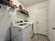 Bright laundry room featuring modern washer and dryer units and shelving for storage at 1380 Delacorte Cir, Shelbyville, IN 46176