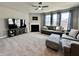 Spacious living room with a fireplace, plush carpeting, large windows, and comfortable seating providing an inviting atmosphere at 1380 Delacorte Cir, Shelbyville, IN 46176