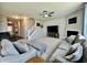 Living room showcasing open floor plan with neutral tones, large sectional, and a fireplace at 1380 Delacorte Cir, Shelbyville, IN 46176