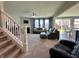 Bright living room featuring neutral colors, a ceiling fan, and large windows with plenty of natural light at 1380 Delacorte Cir, Shelbyville, IN 46176