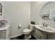 Charming powder room with pedestal sink, modern toilet, and neutral decor at 1380 Delacorte Cir, Shelbyville, IN 46176
