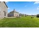 Spacious backyard with green grass, a concrete patio, and mature trees at 145 Stamford Dr, Pittsboro, IN 46167