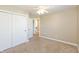 Bedroom featuring a ceiling fan, closet doors and open access to another room at 145 Stamford Dr, Pittsboro, IN 46167