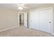 A bedroom featuring double doors leading to the closet and an open door to another room at 145 Stamford Dr, Pittsboro, IN 46167