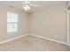 Bedroom featuring a ceiling fan, window, neutral walls and carpet at 145 Stamford Dr, Pittsboro, IN 46167