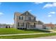 Charming two-story home with brick and gray siding, well-manicured lawn, and attached garage at 145 Stamford Dr, Pittsboro, IN 46167