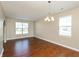 Bright living room with hardwood floors, a chandelier, and natural light from windows at 145 Stamford Dr, Pittsboro, IN 46167