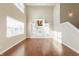Open-concept living room with a two-story ceiling, a built-in entertainment center, and hardwood floors at 145 Stamford Dr, Pittsboro, IN 46167