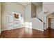 Bright living room with a two-story ceiling, entertainment center, and staircase at 145 Stamford Dr, Pittsboro, IN 46167