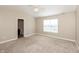 A comfortable main bedroom featuring a ceiling fan, large window, and adjoining bathroom at 145 Stamford Dr, Pittsboro, IN 46167