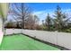 Fenced backyard with artificial turf, a basketball hoop and views of distant greenery for outdoor enjoyment and recreation at 14917 Mia Dr, Carmel, IN 46033