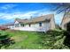 Landscaped backyard featuring a well-kept lawn, garden with retaining walls, and a partial view of the house at 14917 Mia Dr, Carmel, IN 46033