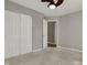 Bedroom features a ceiling fan, double closet doors, carpet and a view of the bathroom at 14917 Mia Dr, Carmel, IN 46033