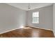 Cozy bedroom featuring hardwood flooring, a modern light fixture, and a window at 14917 Mia Dr, Carmel, IN 46033