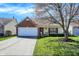 Charming single Gathering home featuring an attached garage and a well-maintained lawn at 14917 Mia Dr, Carmel, IN 46033