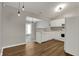 Bright kitchen features white cabinets, modern appliances, and wood-look vinyl flooring at 14917 Mia Dr, Carmel, IN 46033