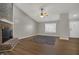 Living room with a brick fireplace, neutral walls, ceiling fan, and vinyl plank flooring at 14917 Mia Dr, Carmel, IN 46033