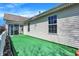 Backyard patio area featuring turf, white siding, and clear views of the house exterior at 14917 Mia Dr, Carmel, IN 46033
