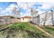 Backyard view featuring a detached garage and fence, ideal for relaxing and outdoor activities at 1504 S Lynhurst Dr, Indianapolis, IN 46241