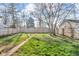 Expansive backyard with a lush green lawn and a wood fence at 1504 S Lynhurst Dr, Indianapolis, IN 46241
