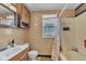 Functional bathroom featuring a tiled shower, window and vanity at 1504 S Lynhurst Dr, Indianapolis, IN 46241