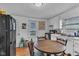 Eat-in kitchen featuring bright white cabinets, laminate floors and natural light at 1504 S Lynhurst Dr, Indianapolis, IN 46241