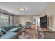 Well-lit living room with hardwood floors, comfortable seating, and a large TV at 1504 S Lynhurst Dr, Indianapolis, IN 46241