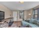 Bright living room with a large window, comfortable sofa, and hardwood floors at 1504 S Lynhurst Dr, Indianapolis, IN 46241