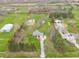 Aerial view of the property, showcasing the house, pond, and surrounding land at 1737 W 200 N, Greenfield, IN 46140