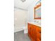 Bright bathroom featuring a bath with shower, white countertop sink, and wood vanity at 1737 W 200 N, Greenfield, IN 46140