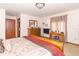 Spacious bedroom with a wooden bed, dresser, vanity, and warm lighting at 1737 W 200 N, Greenfield, IN 46140
