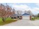Inviting home featuring a brick and blue exterior, an attached garage, and a gravel driveway at 1737 W 200 N, Greenfield, IN 46140