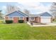 Charming single-story brick home featuring a well-manicured lawn and attached two-car garage at 1737 W 200 N, Greenfield, IN 46140
