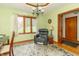 Home office with a comfortable chair, desk, and ample natural light from a large window at 1737 W 200 N, Greenfield, IN 46140