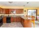 Kitchen with wooden cabinetry, granite countertops, stainless steel appliances, and a view into another room at 1737 W 200 N, Greenfield, IN 46140