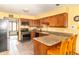 Charming kitchen featuring wood cabinets, granite countertops, and modern appliances at 1737 W 200 N, Greenfield, IN 46140