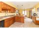 Bright kitchen features granite counters, wood cabinets, stainless sink, and a view into the breakfast room at 1737 W 200 N, Greenfield, IN 46140