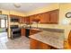 The kitchen features wood cabinets, granite countertops, and stainless steel appliances at 1737 W 200 N, Greenfield, IN 46140