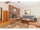Cozy living room with brick fireplace, hardwood floors, comfortable seating, and lots of natural light at 1737 W 200 N, Greenfield, IN 46140