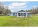 Beautiful blue home showcasing a covered porch, white trim, and a spacious green backyard at 1737 W 200 N, Greenfield, IN 46140