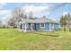 Charming blue home featuring a covered patio with white pillars, perfect for outdoor relaxation at 1737 W 200 N, Greenfield, IN 46140