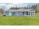 The home's exterior with a backyard, patio, and blue siding is ideal for outdoor activities at 1737 W 200 N, Greenfield, IN 46140