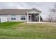 The backyard features a screened-in porch overlooking the lawn and concrete patio at 182 Batteese Dr, Cicero, IN 46034