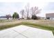 The backyard is finished with a concrete patio and backs up to a grass lawn at 182 Batteese Dr, Cicero, IN 46034