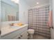 This bathroom includes a bright vanity, matching mirror, and a shower with patterned curtain at 182 Batteese Dr, Cicero, IN 46034