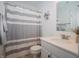 Bright bathroom with white cabinets, modern fixtures, neutral colors, and striped shower curtain at 182 Batteese Dr, Cicero, IN 46034